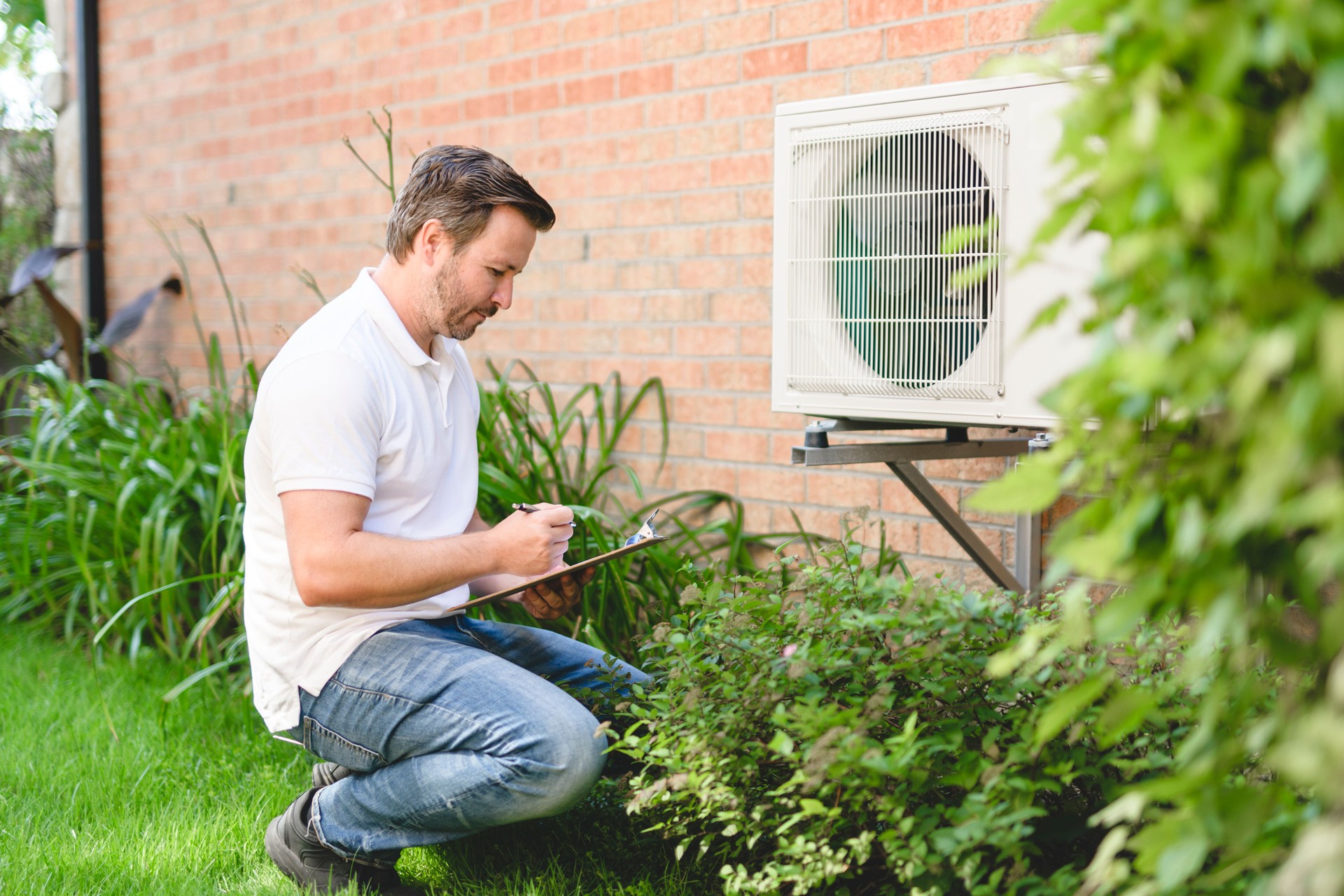 technician working on air conditioning or heat pump outdoor unit
